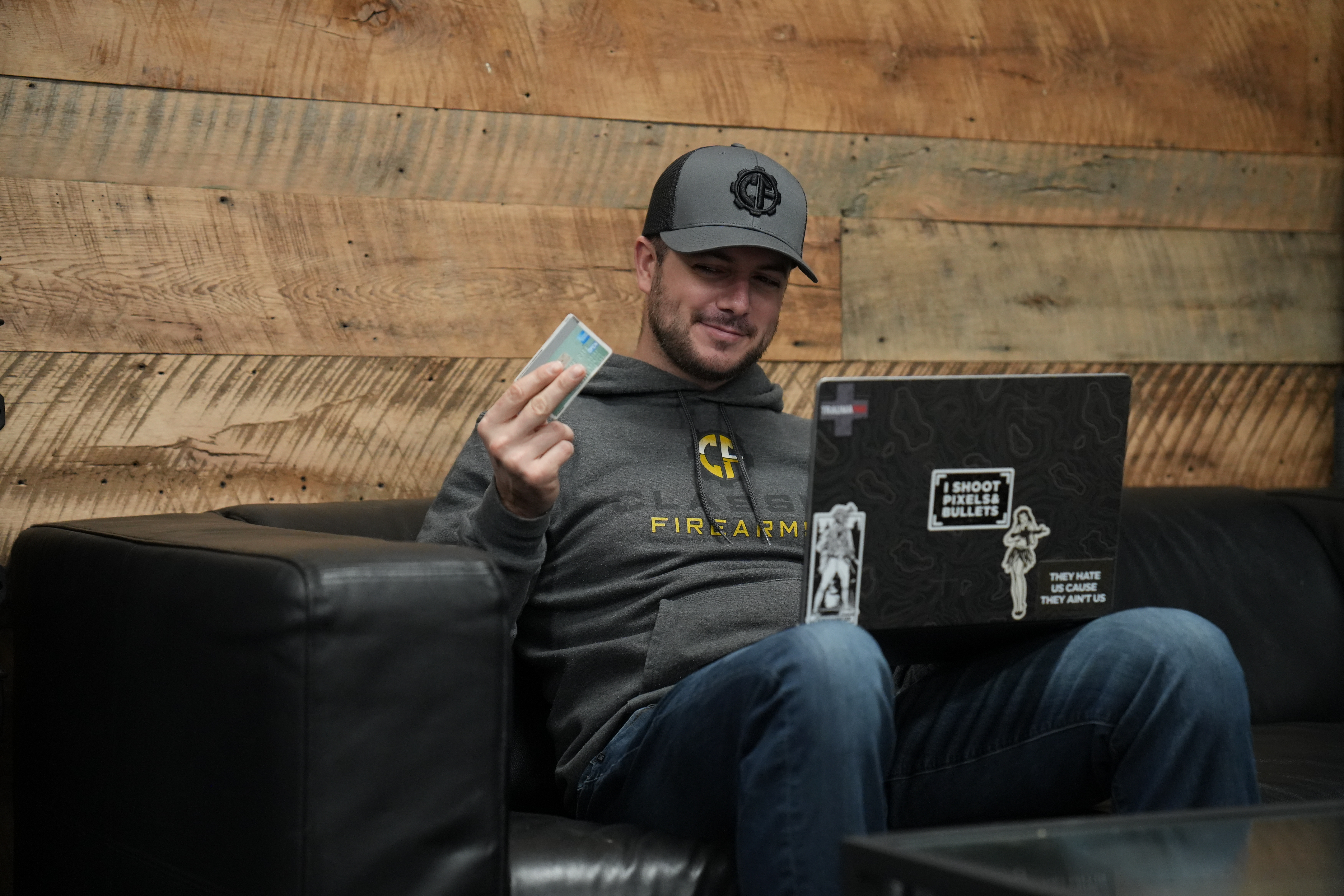 Clint entering his payment information on his laptop